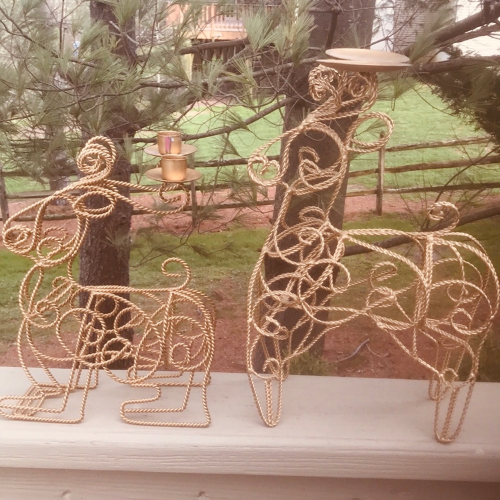 Two twisted gold metal reindeer candle holders